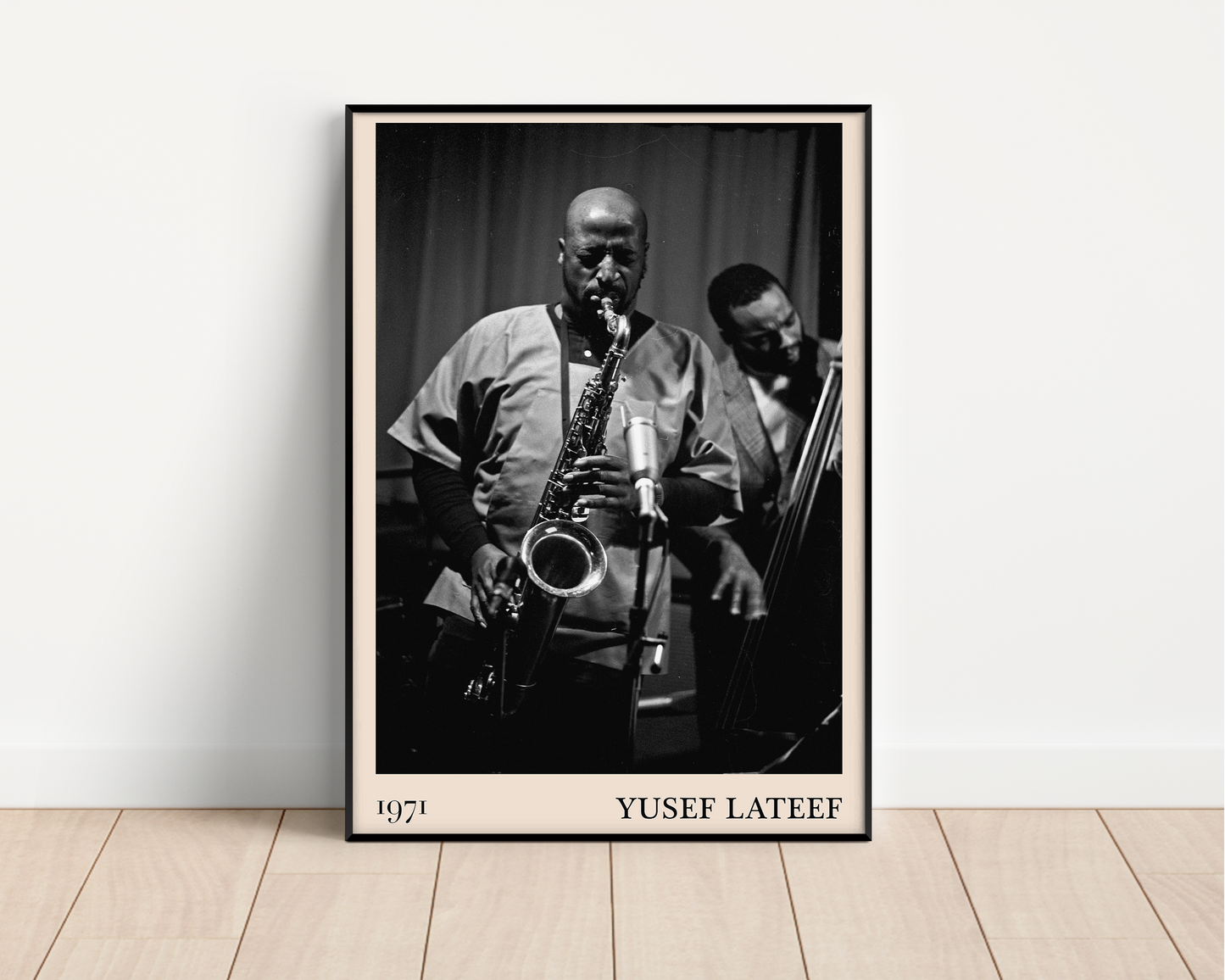 1971 photo of Yusef Lateef crafted into a black framed-poster, leaning against a white wall