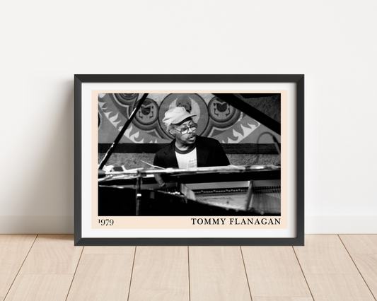 Tommy Flanagan landscape main mount mockup features a framed black and white portrait print, set on a wood floor.