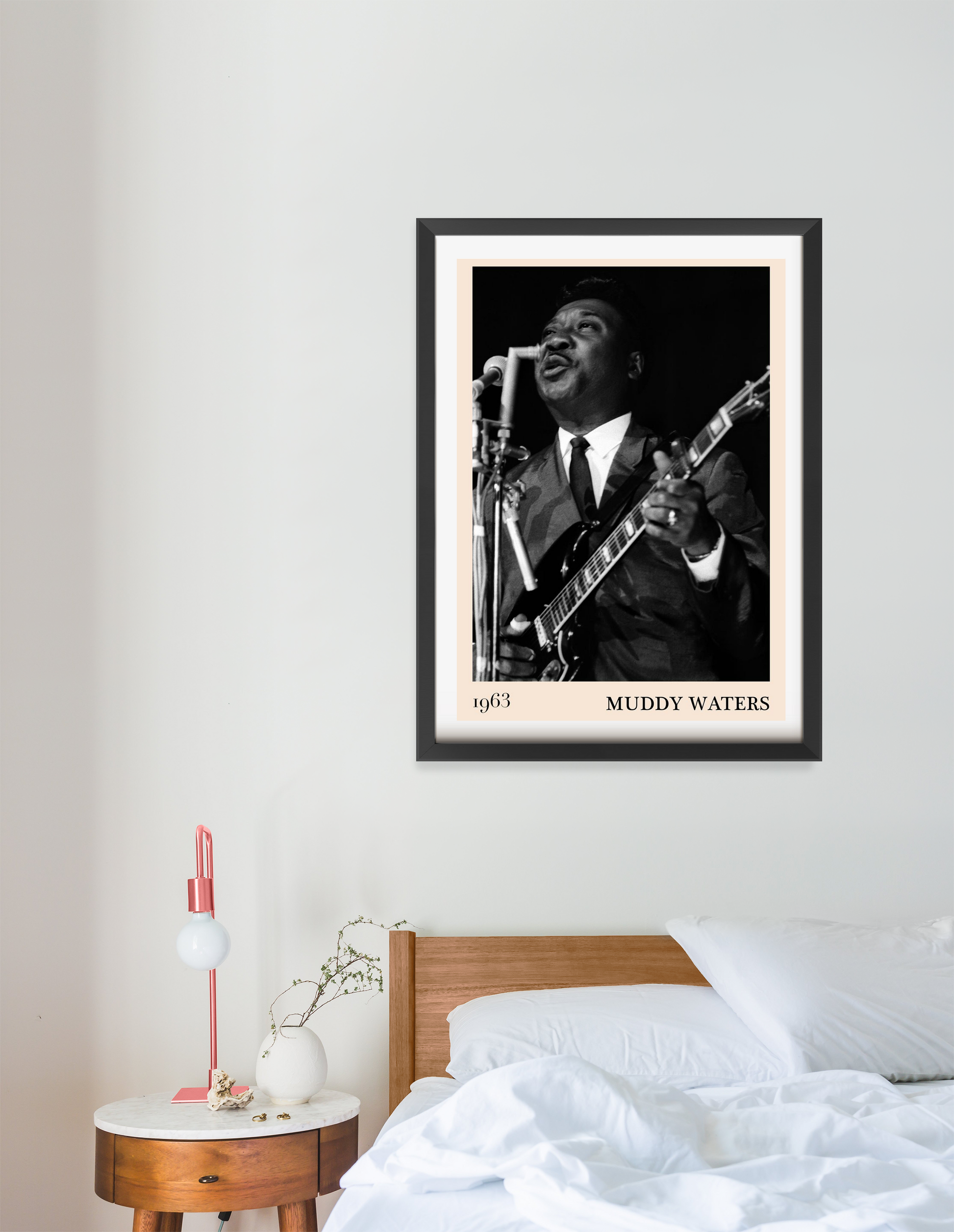 Muddy Water Blues Concert Poster in portrait 16 mount mockup above a modern bed, featuring a black and white musician print.