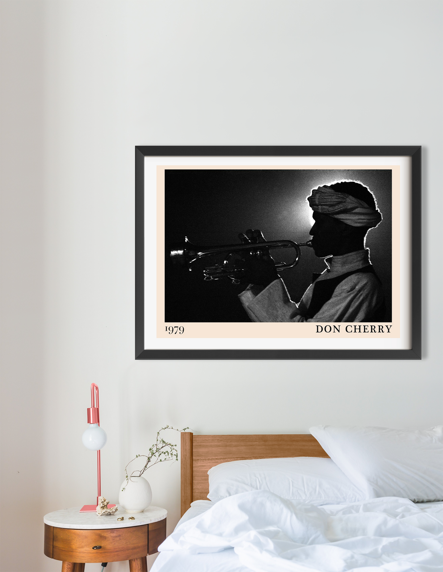 Don Cherry Jazz Poster in landscape 16 mount mockup above a modern bed, featuring a black and white trumpet silhouette design
