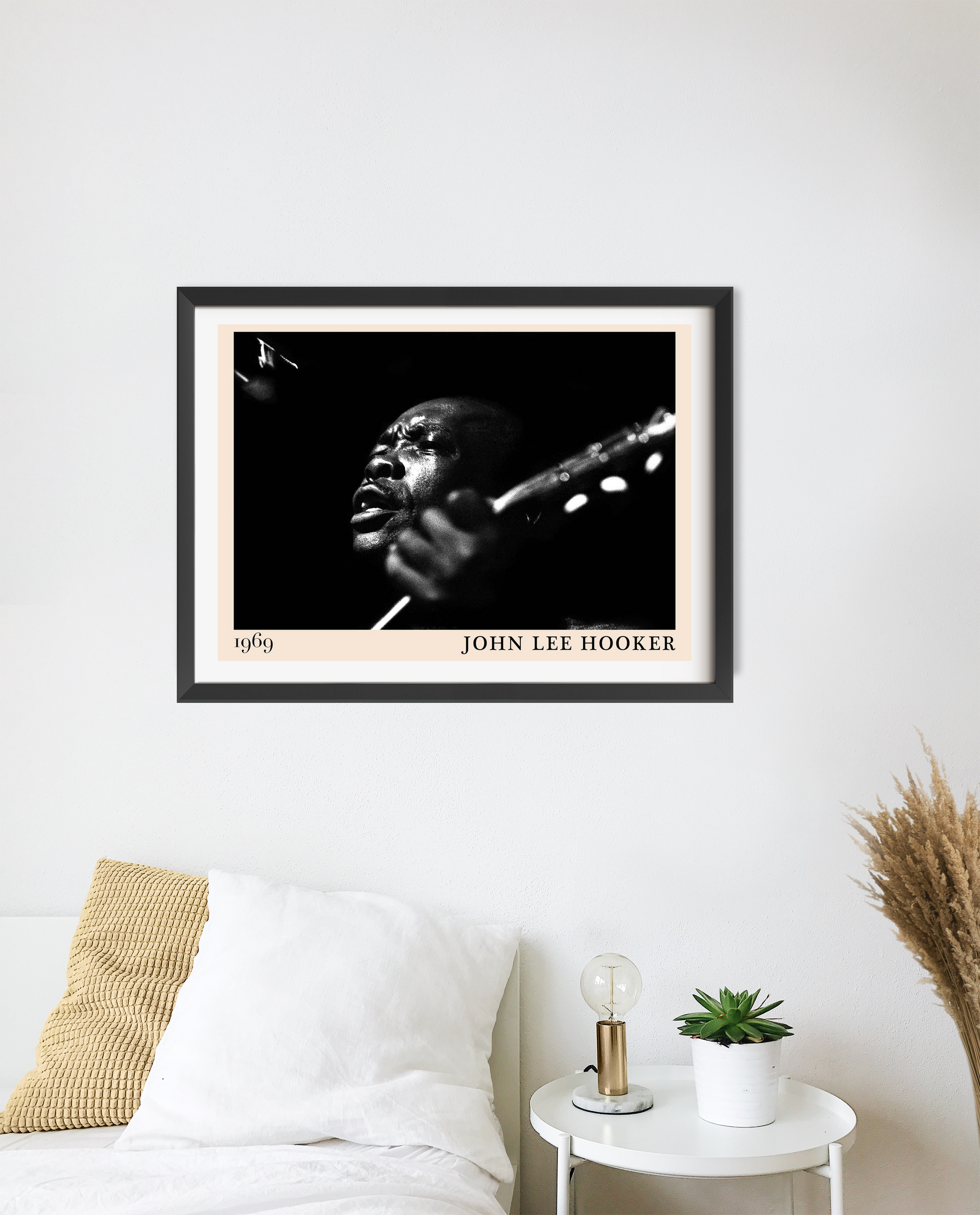 John Lee Hooker Retro Blues Poster in landscape 20 mount above a modern white bed, featuring bold black and white portrait de