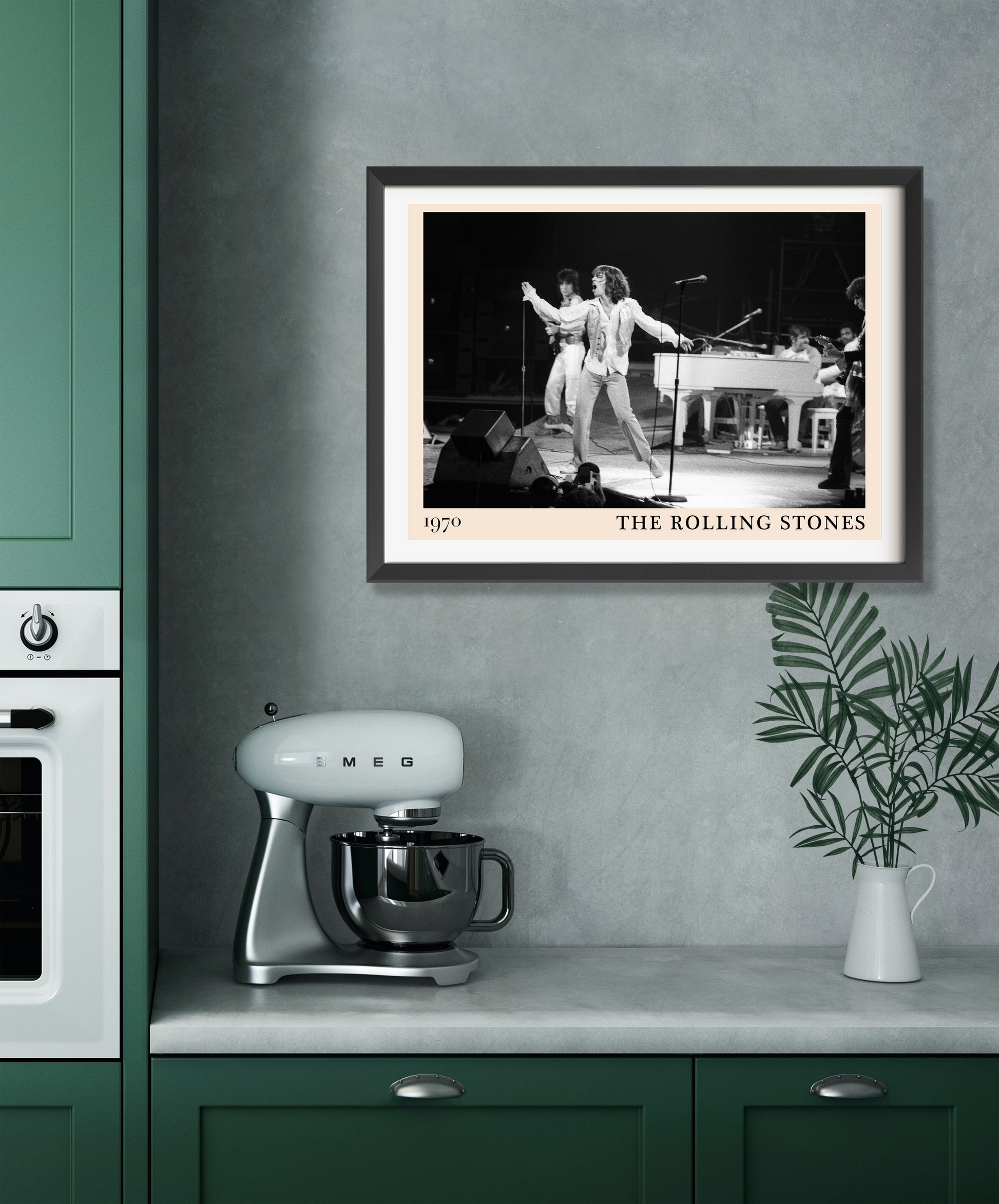 The Rolling Stones Retro Concert Poster in a black frame on a kitchen wall, featuring a 1970s band performance in black and w
