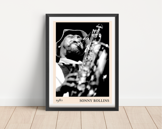 Sonny Rollins Jazz Concert Poster in portrait main mount mockup, black frame on wood floor, bold black and white saxophone de