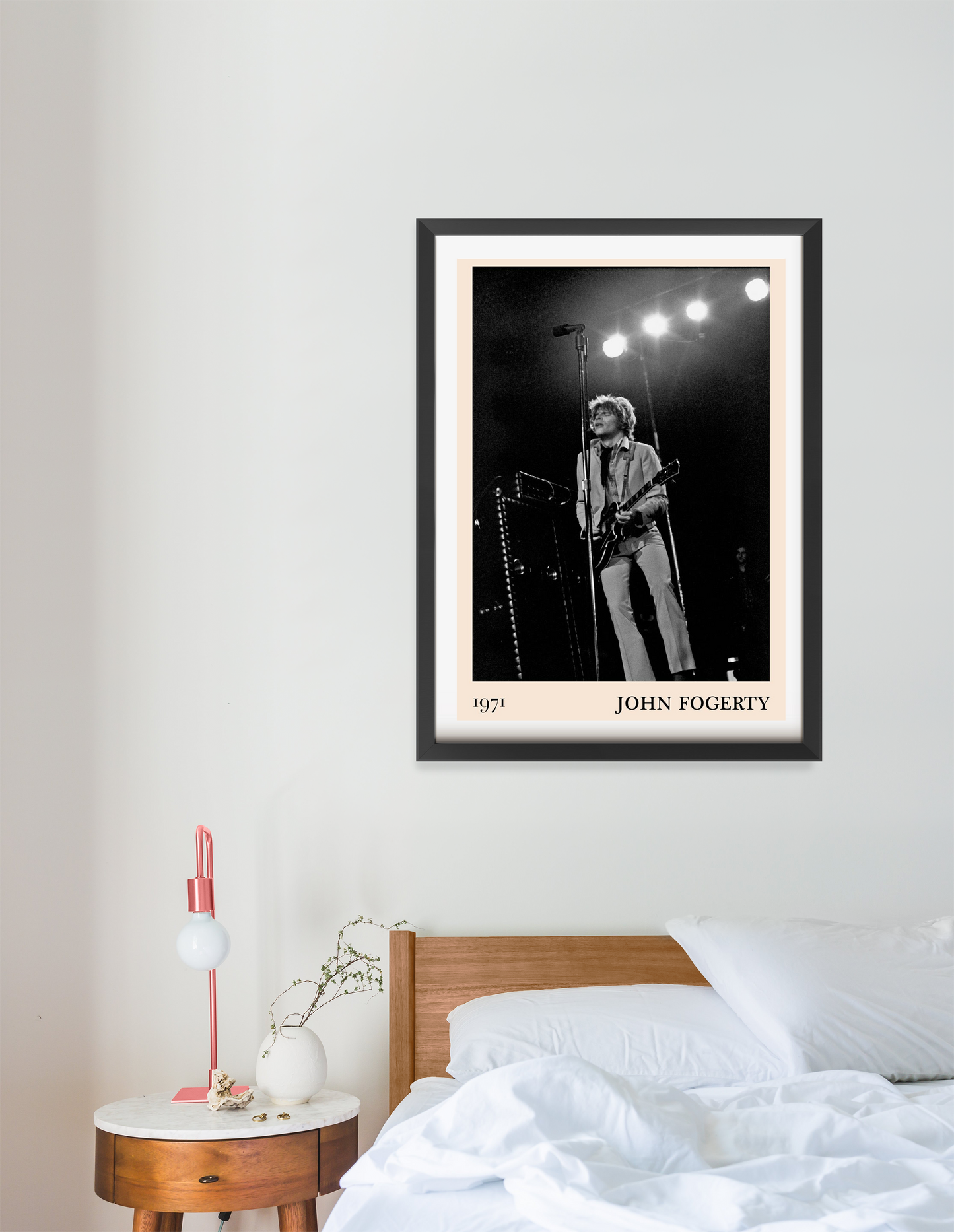 John Fogerty Retro Rock Poster in portrait 16 mount above a modern bed, featuring a black-and-white 1971 concert photo.