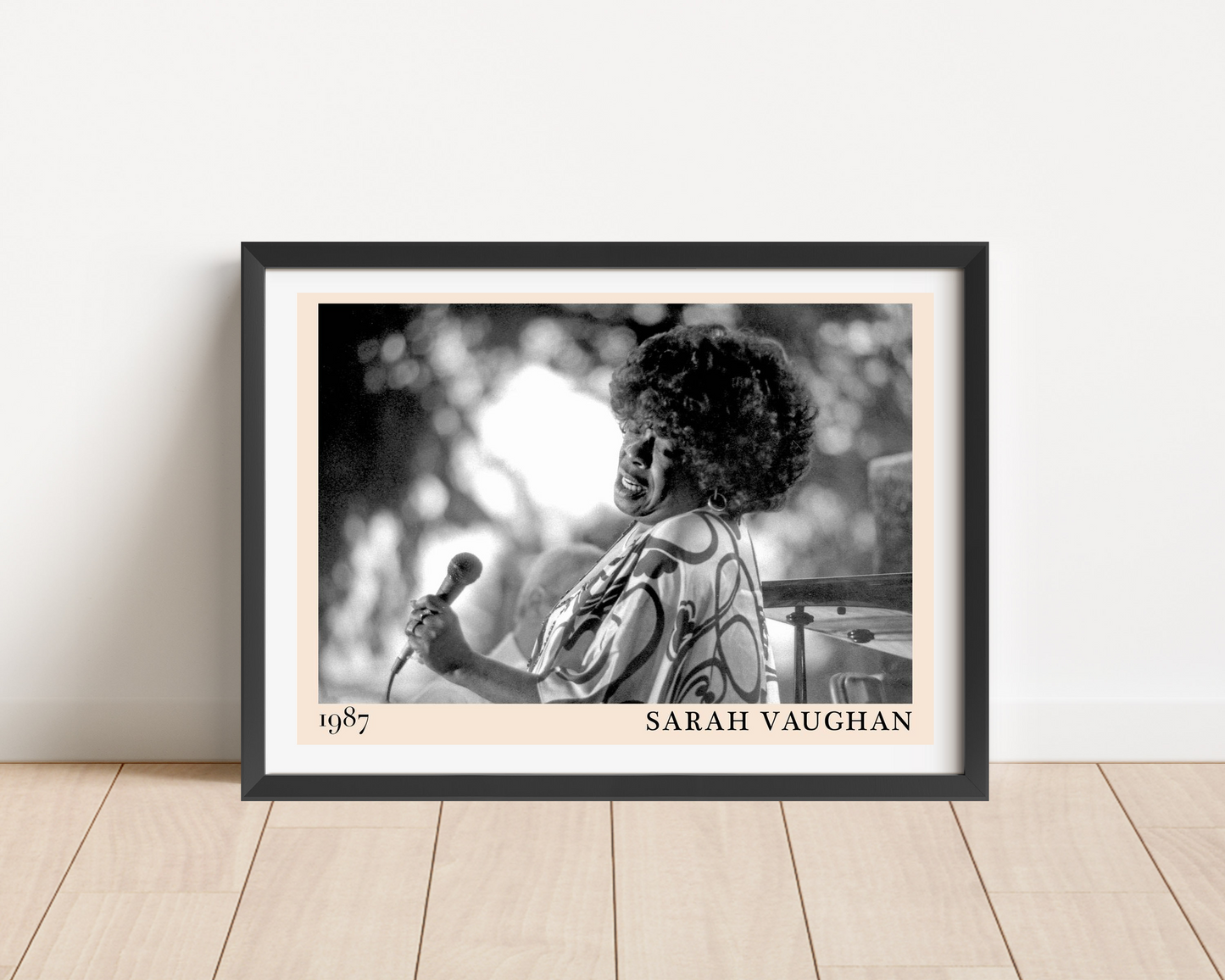 Sarah Vaughan Jazz Poster in landscape frame mockup on wood floor, features black and white portrait with 1987 date and name.