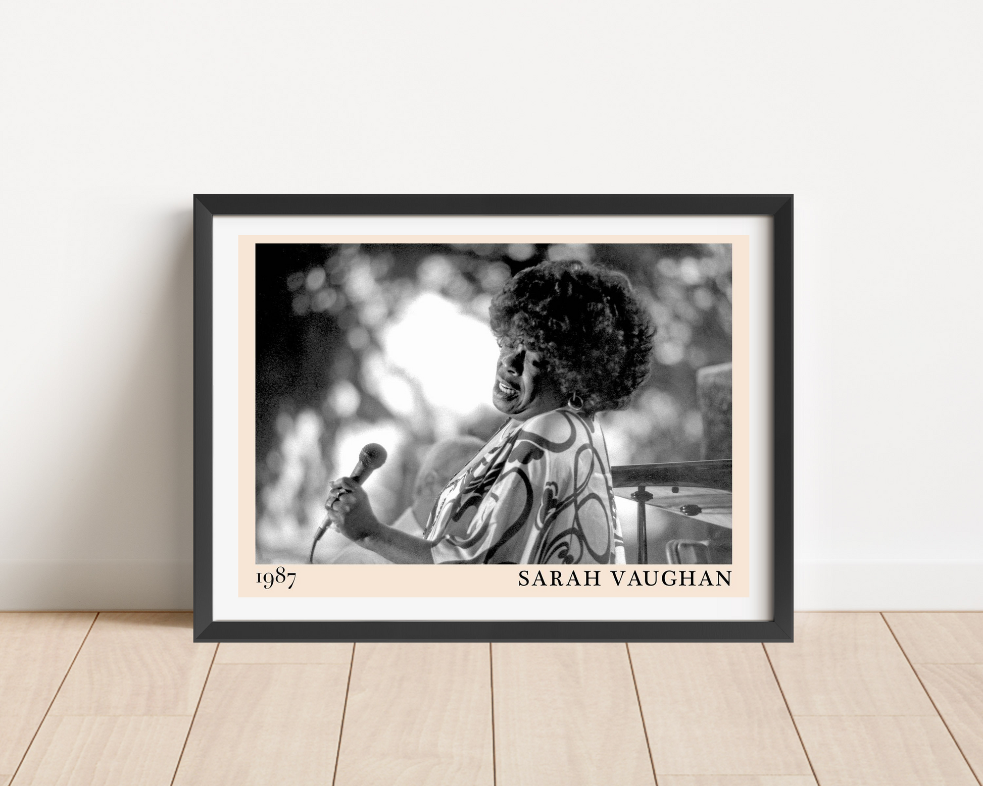 Sarah Vaughan Jazz Poster in landscape frame mockup on wood floor, features black and white portrait with 1987 date and name.