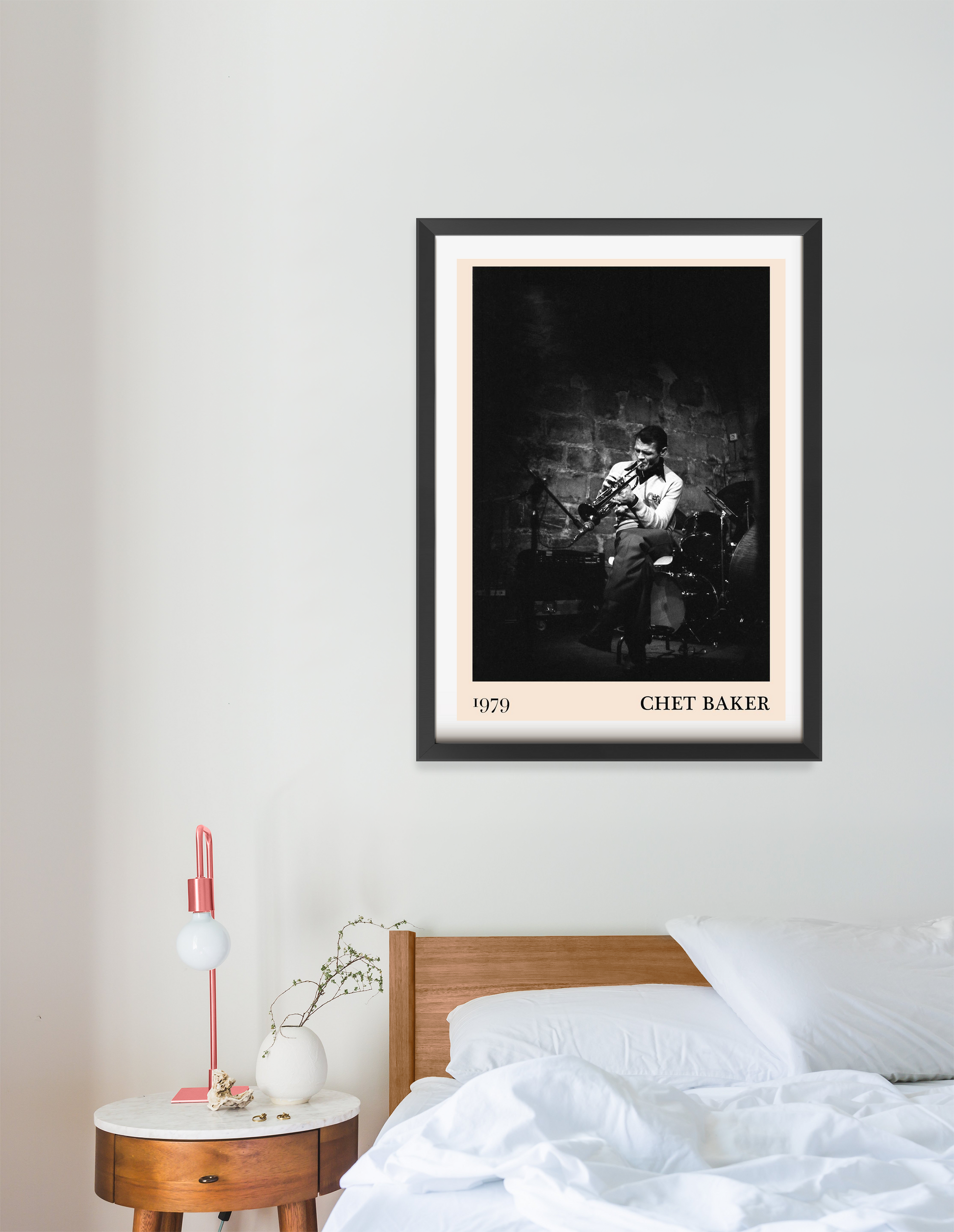 Chet Baker vintage concert poster in portrait 16 mount mockup above a modern bed, black-and-white jazz photo design.