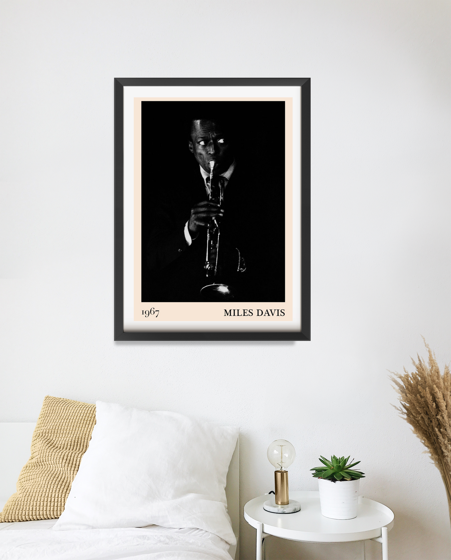 Miles Davis vintage jazz poster in portrait 20 mount mockup above a modern bed, featuring black and white trumpet photo.