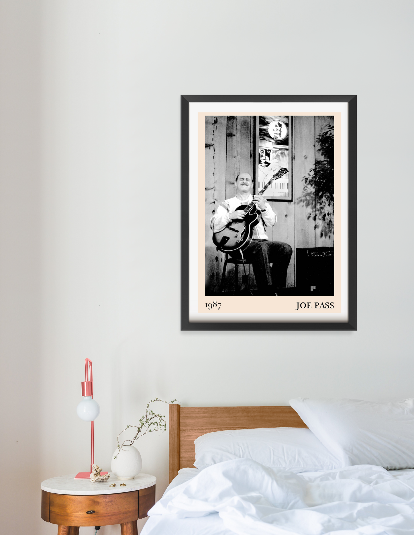 Joe Pass Retro Jazz Poster in Portrait 16 Mount above a modern bed, featuring black and white jazz musician artwork, cozy dec