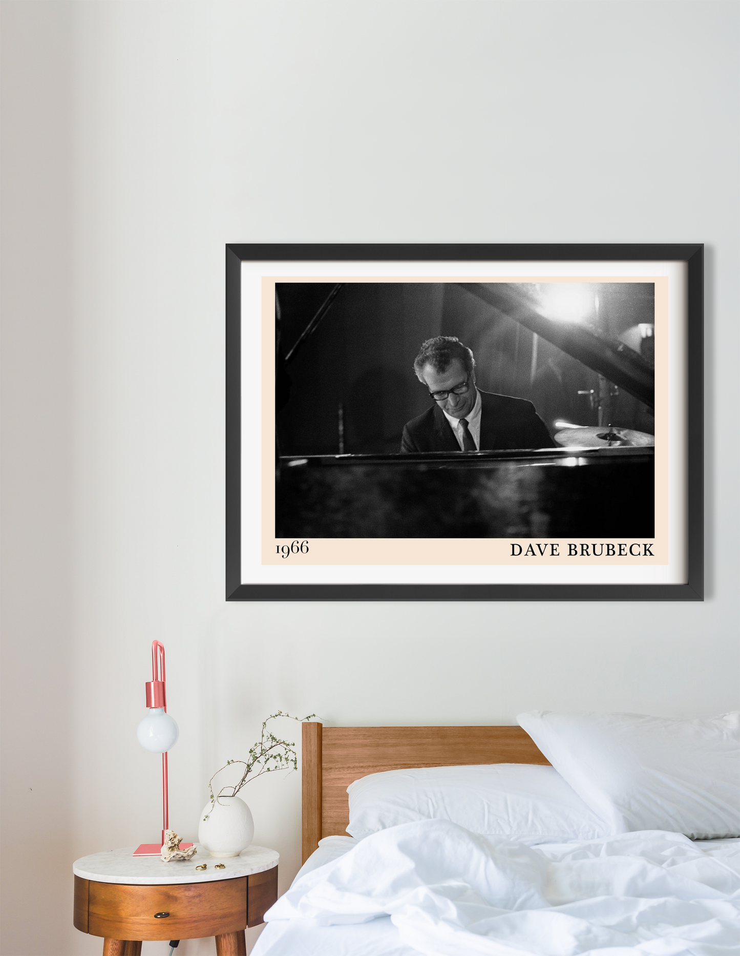 Dave Brubeck Retro Jazz Poster in landscape 16 mount mockup above a modern bed, featuring a black and white pianist design.