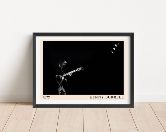 Kenny Burrell Jazz Concert Poster in landscape frame mockup, black and white photo design with 1977 date on wood floor.