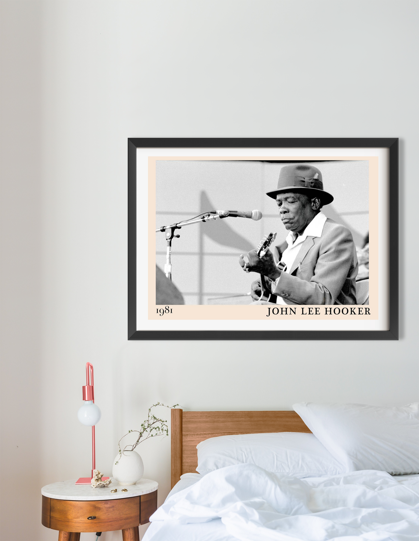 John Lee Hooker Blues Poster in landscape 16 mount mockup, black and white design framed above a modern bed in a cozy bedroom