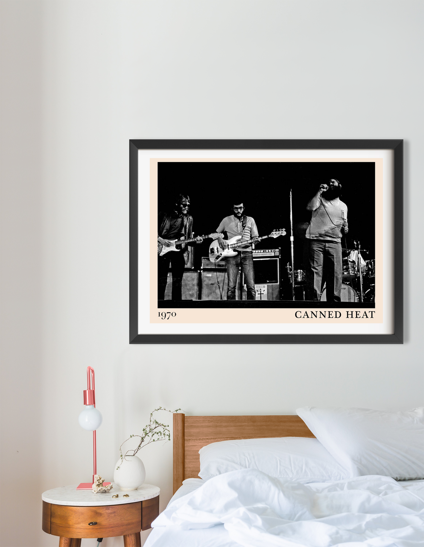Canned Heat Poster in landscape 16 mount mockup above a modern bed, featuring a vintage black and white band photo.
