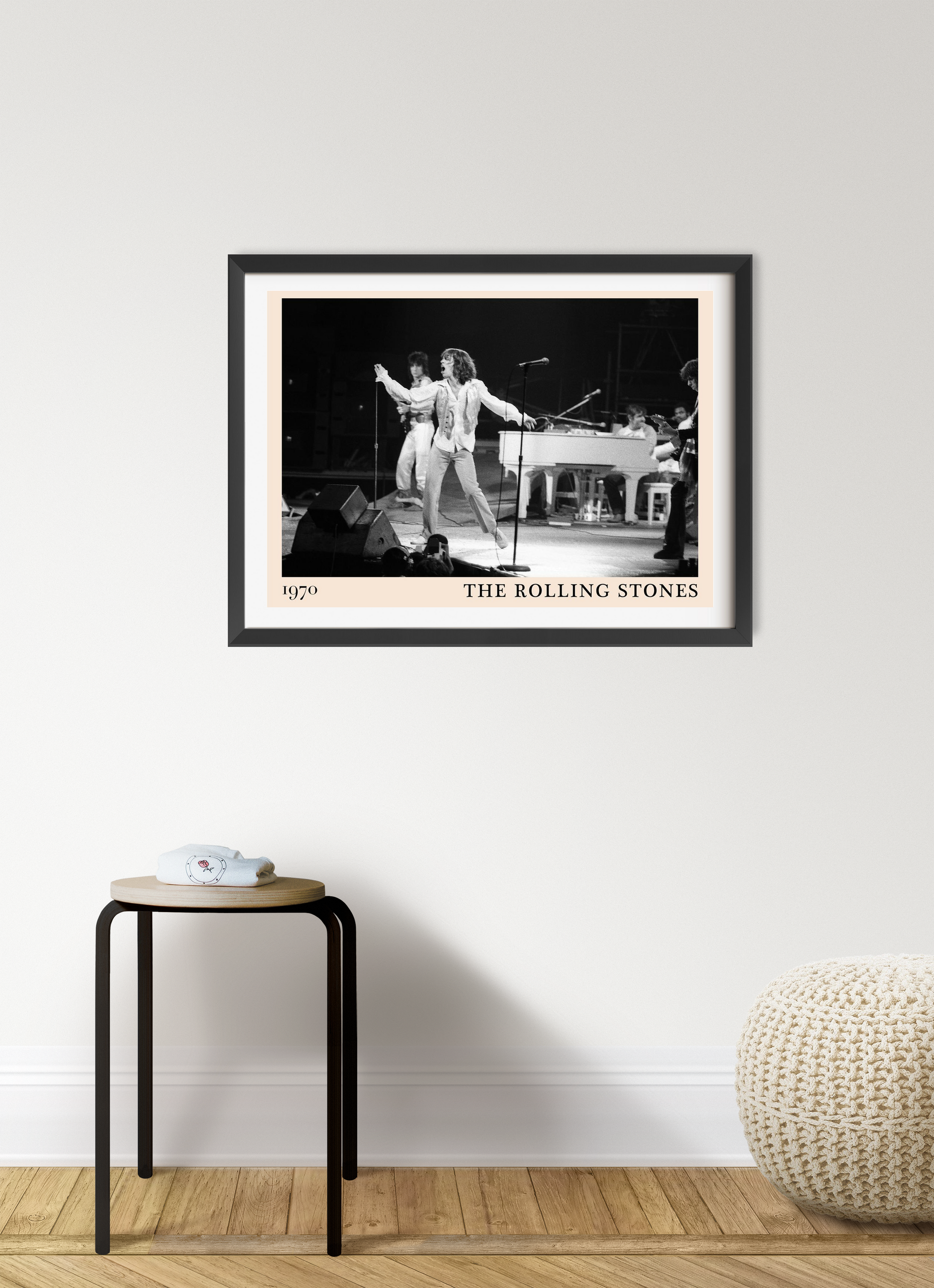 The Rolling Stones retro concert poster in landscape mount mockup, black and white band photo framed on modern wall.