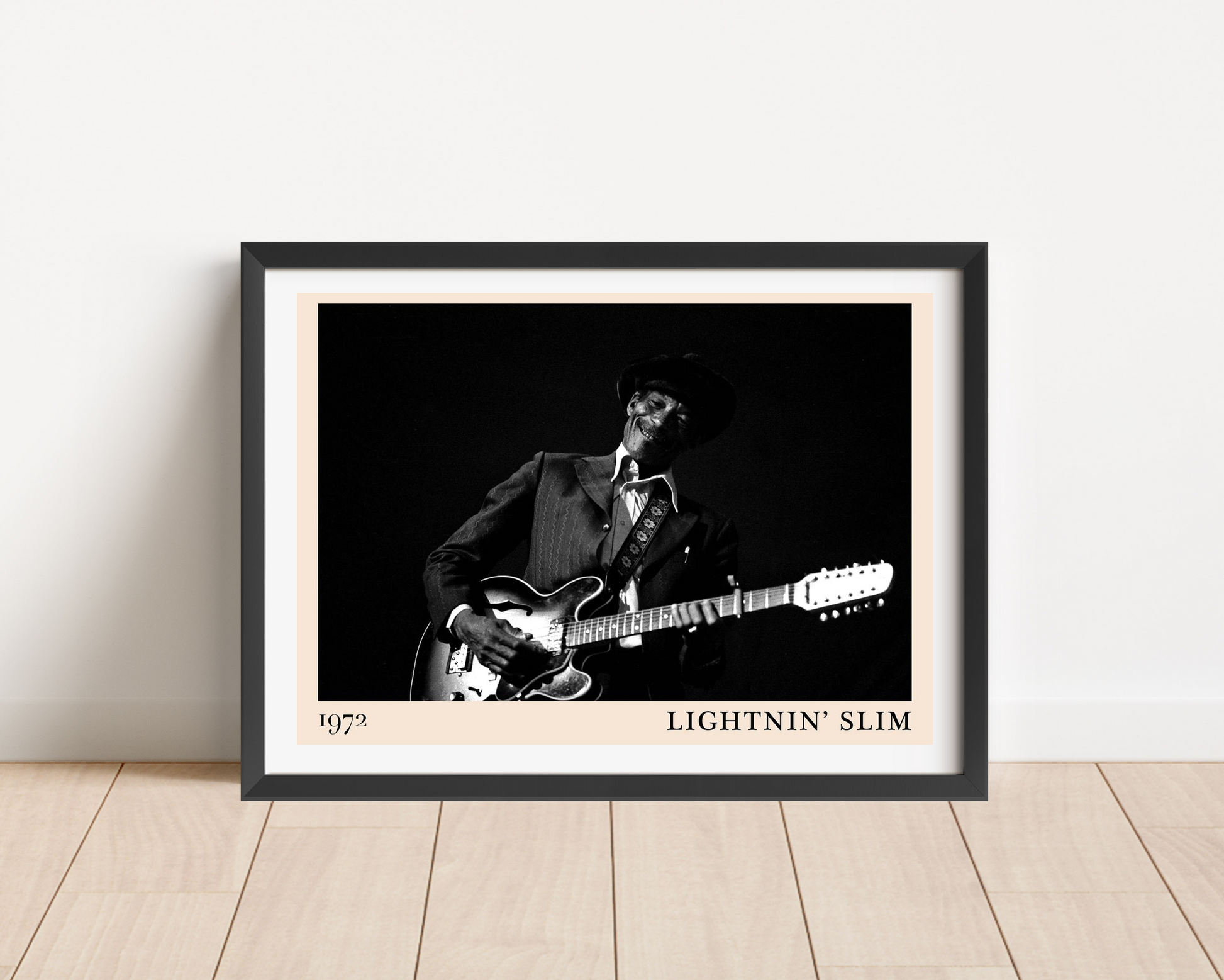 Lightnin Slim Blues Poster in landscape main mount mockup, black-and-white design with guitarist, framed on wood floor.