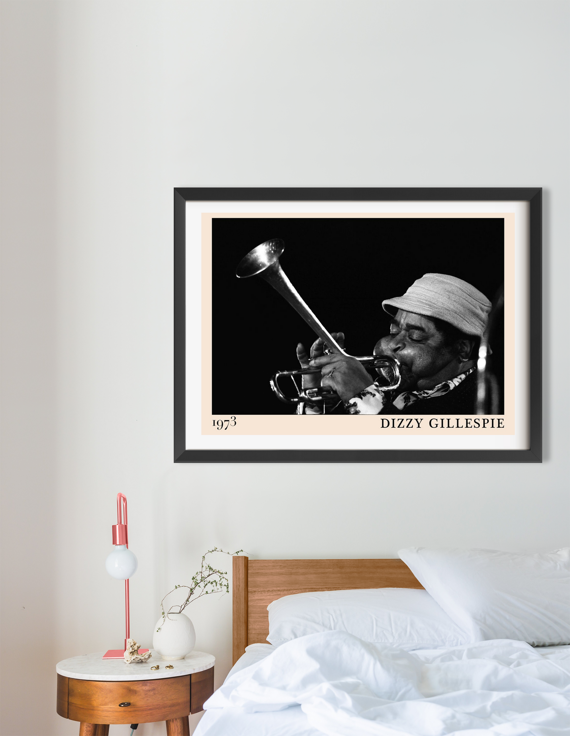 Dizzy Gillespie Jazz Concert Poster in landscape 16 mount above a modern bed, featuring black and white trumpet photo.