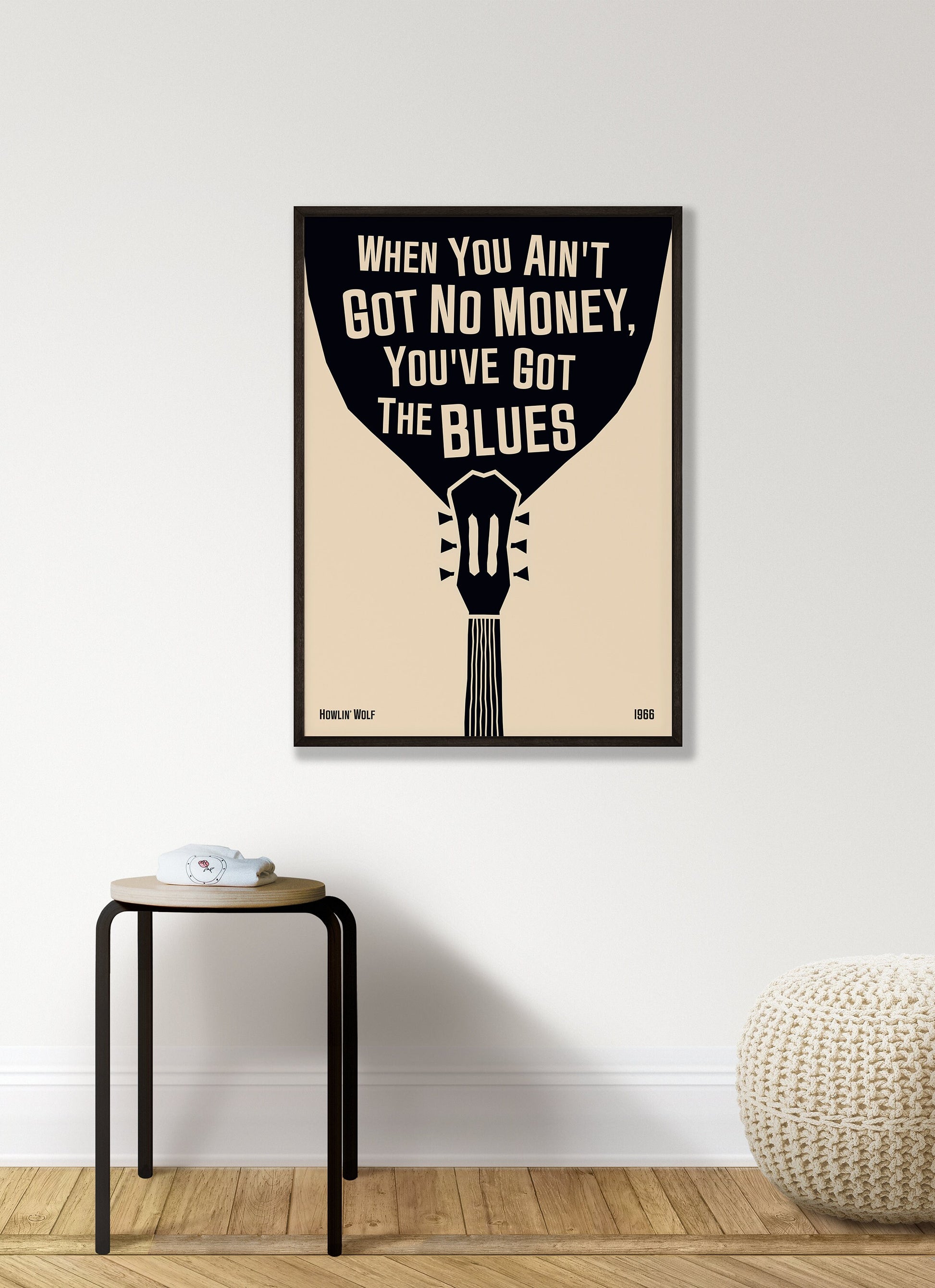 Cool blues music poster with guitar design, featuring a Howlin' Wolf quote. Retro black frame print, hanging on a white living room wall, perfect home decor.